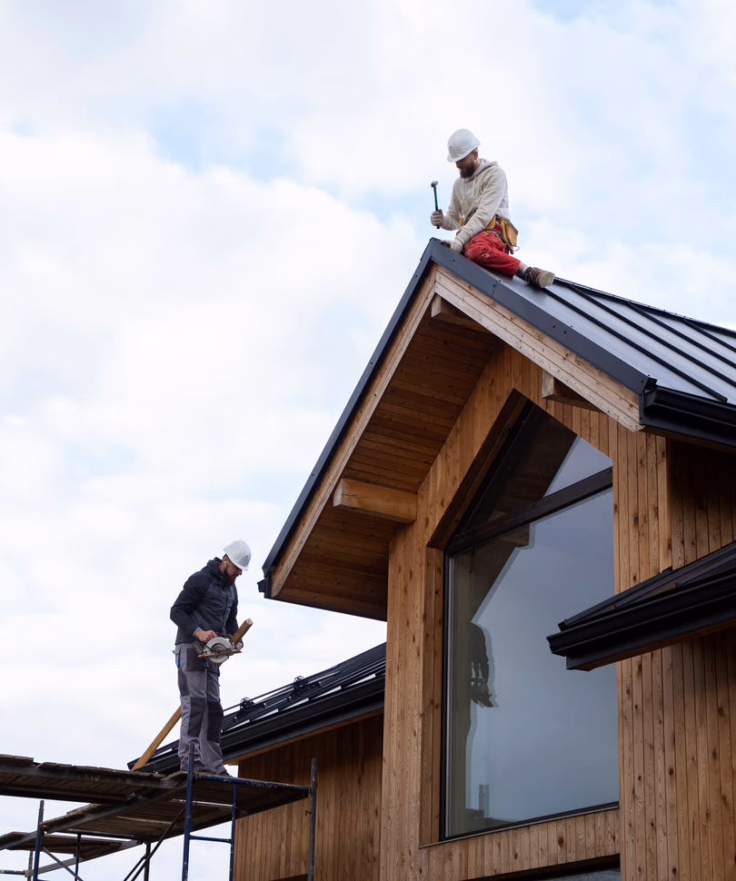 two men working on construction of a roof